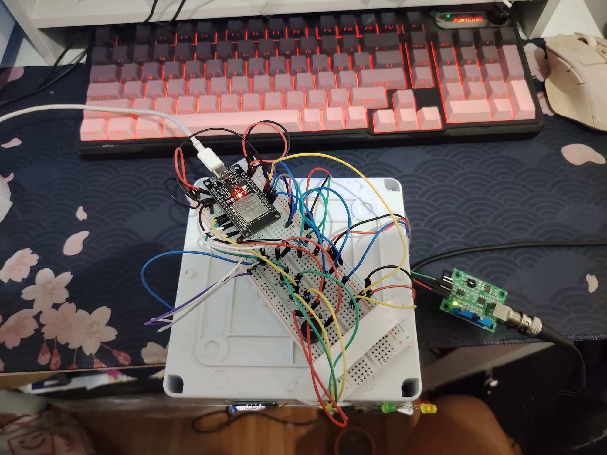 The breadboard build on the bench, wired to a sensor module.