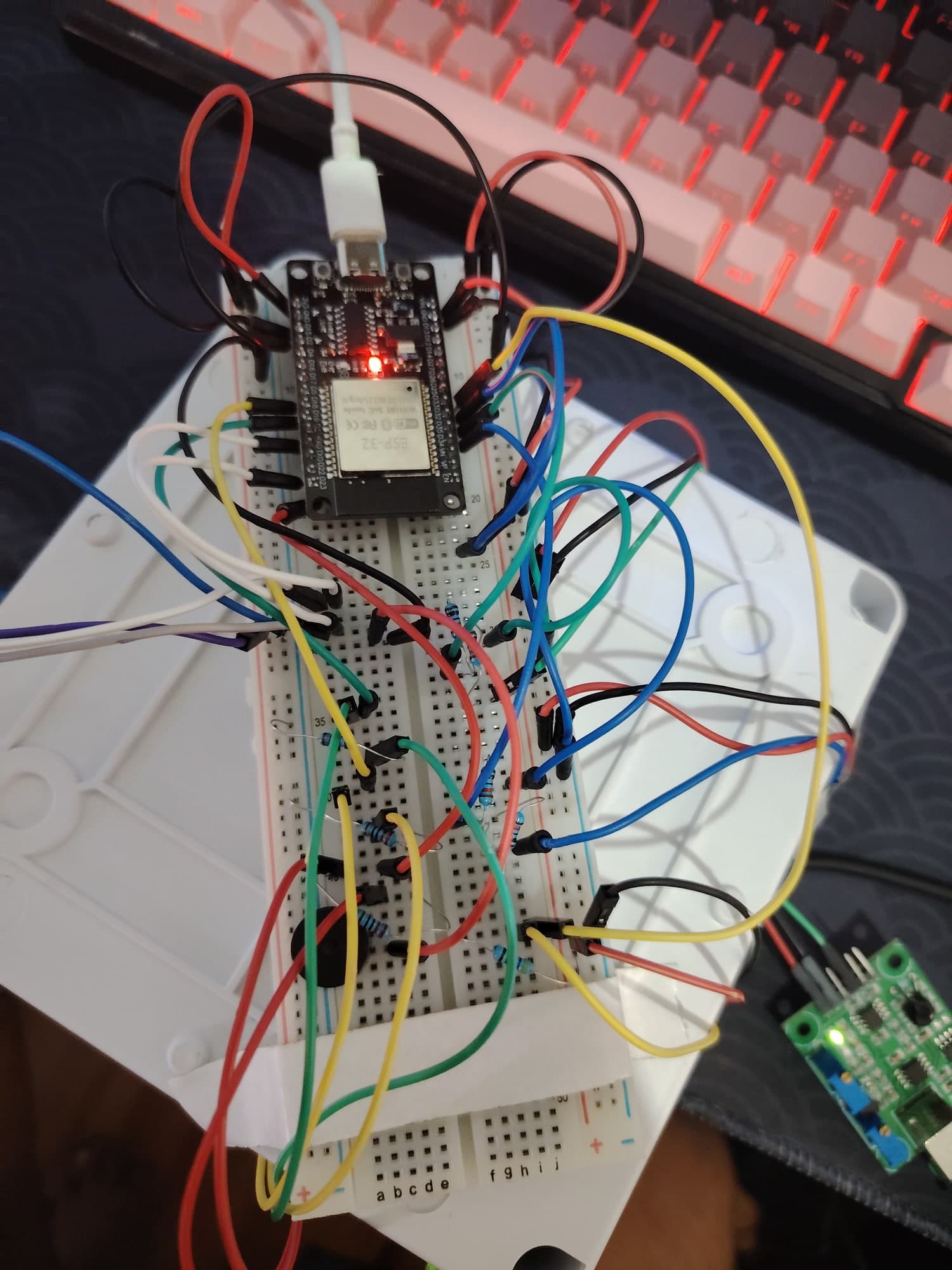 The ESP32 on a breadboard, wired to indicator LEDs and sensor inputs during development.